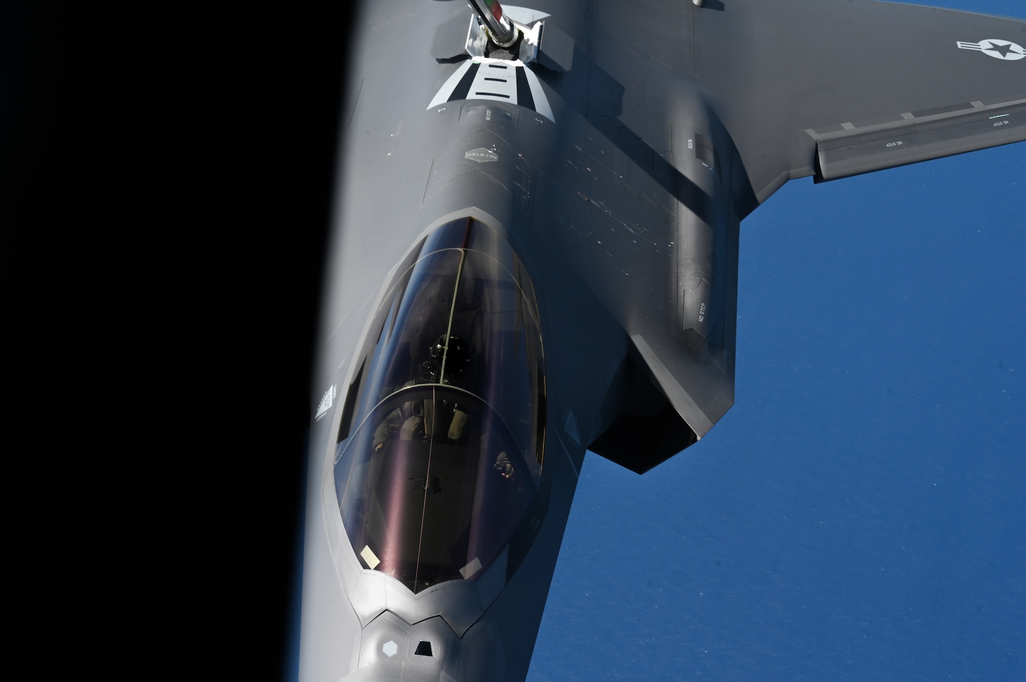 An aircraft conducts aerial refueling.
