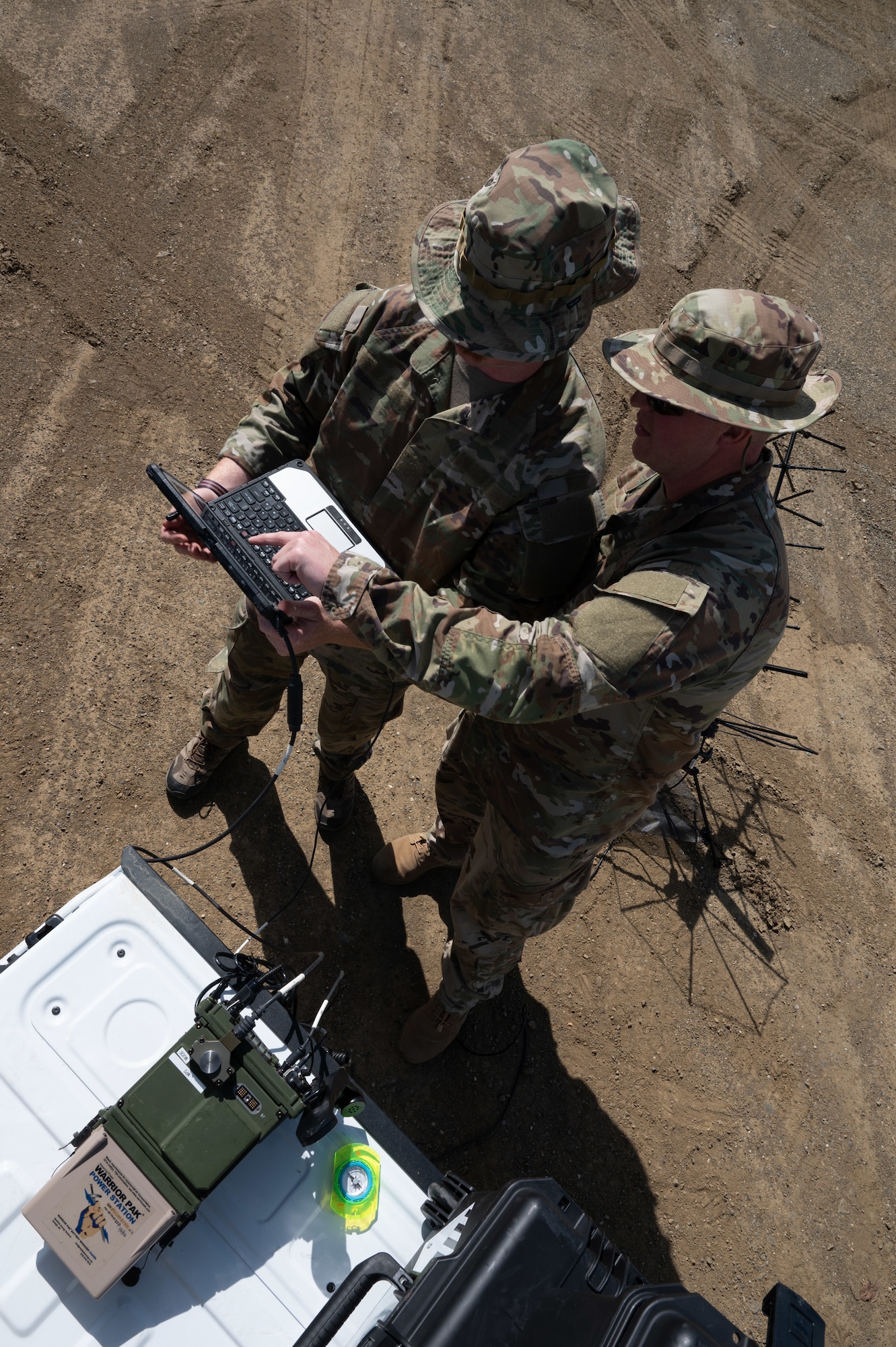 U.S. Air Force Tech Sgt. Laramie Grisba (left) and Tech Sgt. Collin Lopes (right) radio frequency transmission systems specialists from the 55th and 35th Combat Communications Squadrons, Tinker Air Force Base, Oklahoma set up a high frequency radio communication device in Coldfoot, Alaska as part of Phase 2 of AGILE BLIZZARD-UNIFIED VISION June 11, 2023. The equipment checks were successful at each location on the way to and further north of Coldfoot, Alaska. (U.S. Air Force photo by Staff Sgt. Dana Tourtellotte)
