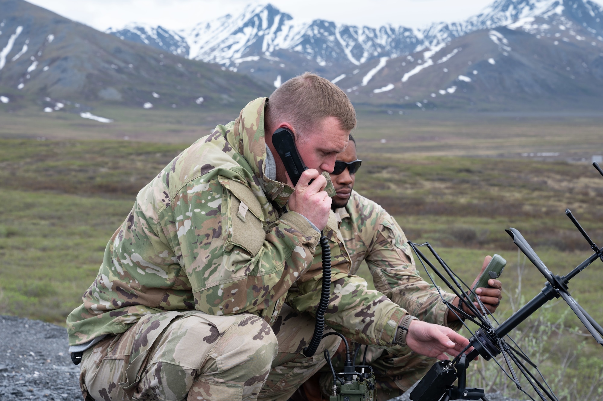 U.S. Air Force Airmen from the 55th and Combat Communications Squadrons, Tinker Air Force Base, Oklahoma remotely establish communication from northern Alaska with counterparts in Tinker AFB and British Columbia using a ultra high frequency antenna and a high frequency radio as part of Exercise AGILE BLIZZARD-UNIFIED VISION Phase II on  June 13, 2023. This portion of the exercise took place north of Coldfoot, Alaska close to 100 miles into the arctic circle. (U.S. Air Force photo by Staff Sgt. Dana Tourtellotte)