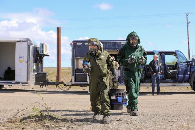 Alaska Army National Guard Staff Sgt. Fabiana Kirtley, left, survey team chief, and Alaska Air National Guard Tech Sgt. Conrad Slocum, survey team member, both with the 103rd Weapons of Mass Destruction - Civil Support Team, prepare for initial entry into a notional lab believed to be capable of manufacturing biological weapons at the Nome, Alaska, Fire Training Center as part of Exercise ORCA 2023, June 12. During initial entry the team uses handheld radiation and nerve, blister, and blood agent detectors as part of the site characterization process. The biennial exercise includes units from five other states and is part of the CST’s routine training schedule, designed to maintain readiness, validate response procedures, and collaborate with community first response agencies across the state.