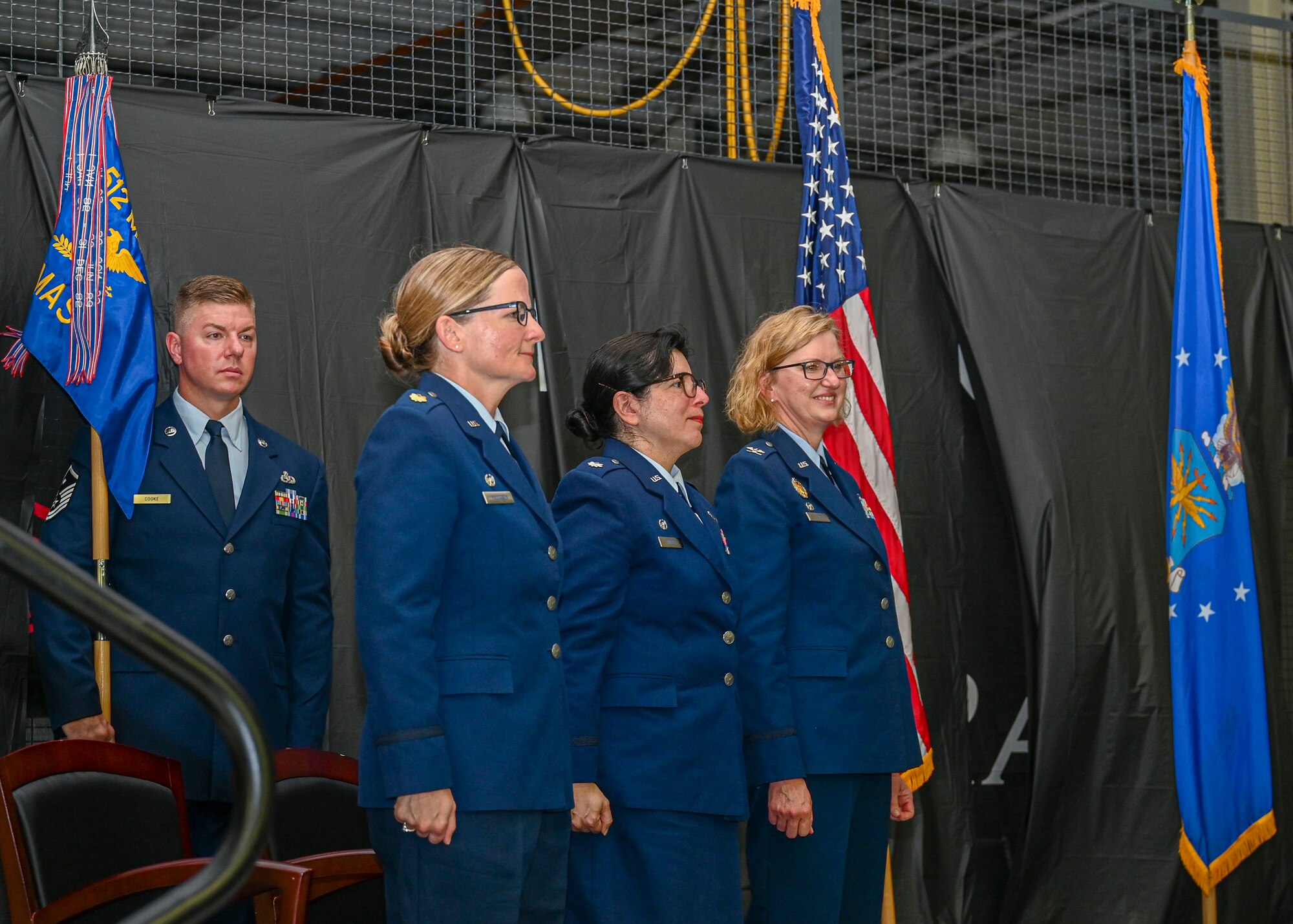 Maj. Deborah Hautanen (far left), 512th Force Support Squadron commander, Lt. Col. Nancy Harper (center), 512th Memorial Affairs Squadron commander and Lt. Col. Crystal Beach, 512th Mission Support Group commander, stand at attention during a dual assumption of command ceremony on Dover Air Force Base, Delaware, July 8, 2023. Beach presided over the ceremony, where Hautaunen and Harper assumed command of the 512th Force Support and Memorial Affairs squadrons, respectively. (U.S. Air Force photo by Senior Airman Shayna Hodge)