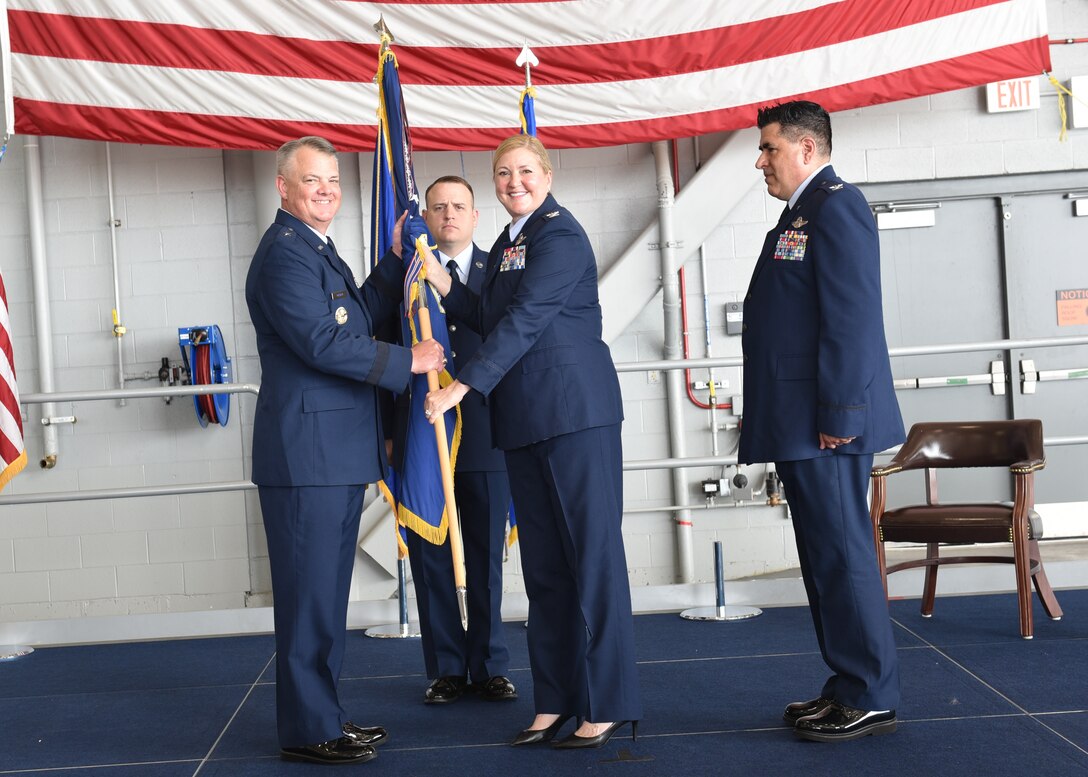 Col. Lara Morrison (center right), 914th Air Refueling Wing commander, hands the 914th guidon to Brig. Gen. D. Scott Durham, 4th Air Force commander, as she prepares to relinquish command during a change of command ceremony July 7, 2023 at Niagara Falls Air Reserve Station, New York.