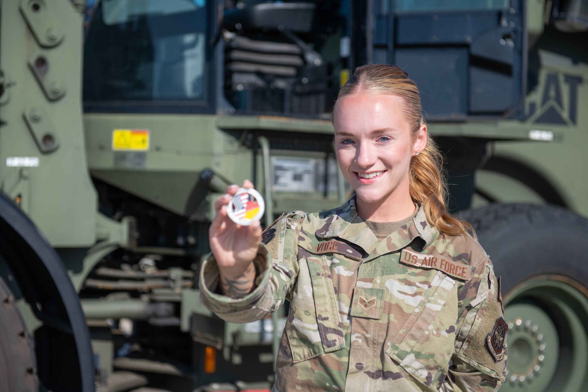 Airman holds up a coin