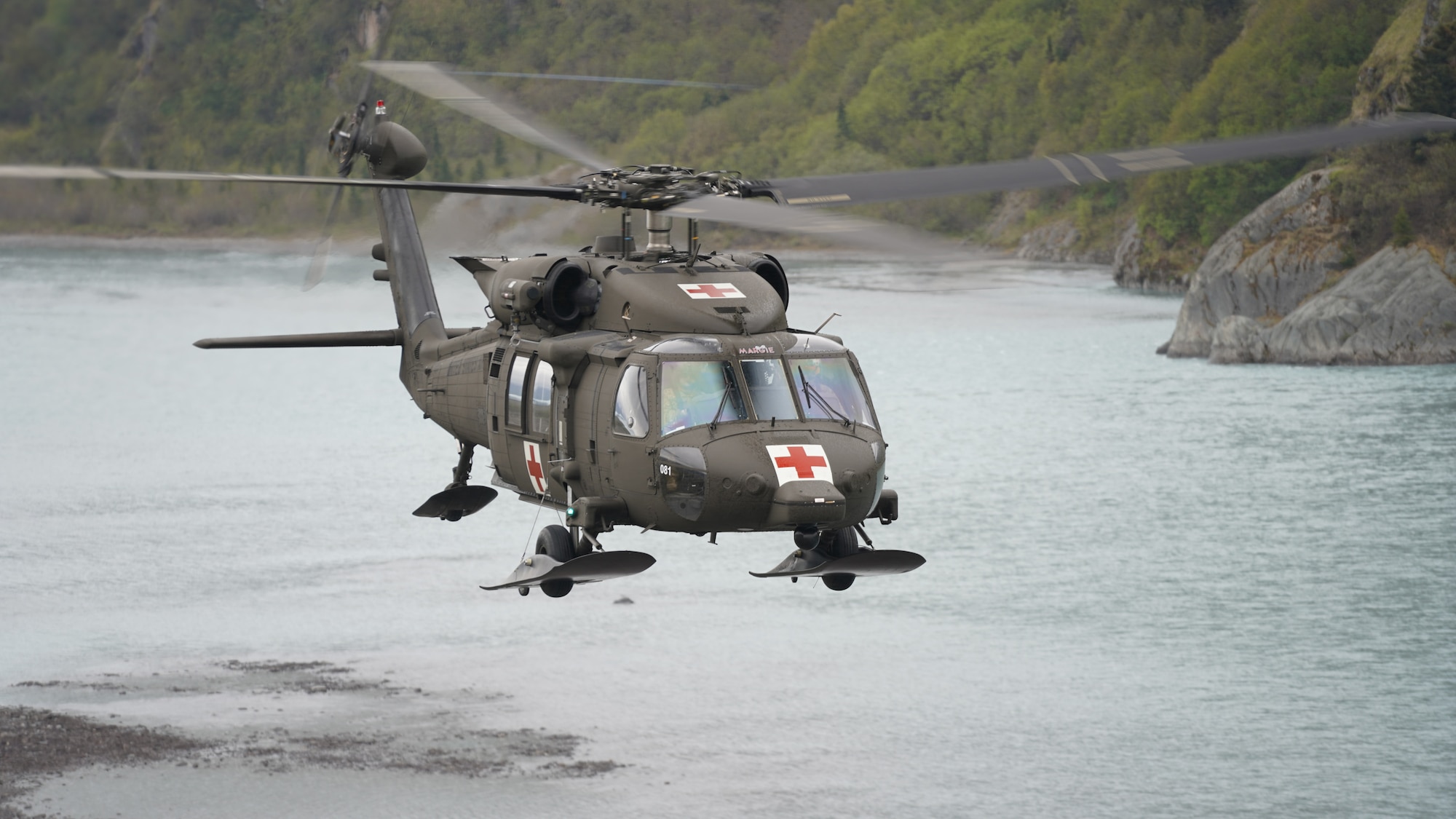 An Alaska National Guard HH-60M Black Hawk helicopter from Golf Company, 2-211th General Support Aviation Battalion, conducts a training mission May 31, 2023, near Colony Glacier.