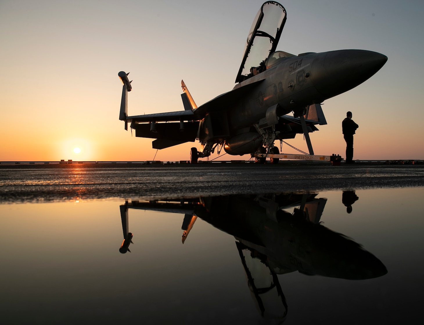 An E/A-18G attached to the "Grey Wolves" of Electronic Attack Squadron (VAQ) 142, sits chocked and chained to the flight deck of the world's largest aircraft carrier USS Gerald R. Ford (CVN 78), July 9, 2023. VAQ-142 is deployed aboard Gerald R. Ford as part of Carrier Air Wing (CVW) 8. USS Gerald R. Ford is the U.S. Navy's newest and most advanced aircraft carrier, representing a generational leap in the U.S. Navy's capacity to project power on a global scale. The Gerald R. Ford Carrier Strike Group is on a scheduled deployment in the U.S. Naval Forces Europe area of operations, employed by U.S. Sixth Fleet to defend U.S., allied, and partner interests. (U.S. Navy photo by Mass Communication Specialist 2nd Class Jackson Adkins)