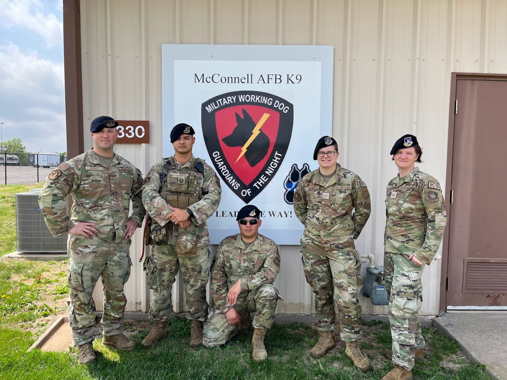 Members of the 22nd Security Forces Squadron K9 unit at McConnell Air Force Base, Kansas. From left to right, Tech. Sgt. Noah Hyatt, kennel master, Senior Airman Joseph Fox, Staff Sgt. Joshua Espinoza Stewart, Senior Airman Ashley Skeels and Staff Sgt. Kaitlyn Coble. (U.S. Army photo by Christine Paul)