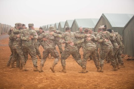 145th Field Artillery Soldiers dance in the Moroccan rain