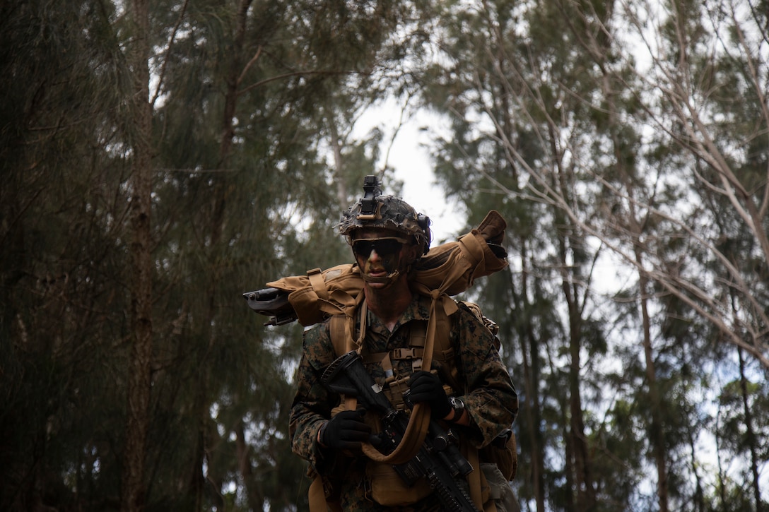 A U.S. Marine with Advanced Infantry Training Battalion, School of Infantry-West, Hawaii Detachment, patrol to an equipment staging area during an Advanced Infantry Marine Course, Kahuku Training Area, Hawaii, June 26, 2023. AIMC is advanced infantry training designed to enhance and test Marines’ skills with a focus on reinforcing proper patrols and operational procedures. (U.S. Marine Corps photo by Lance Cpl. Terry Stennett III)