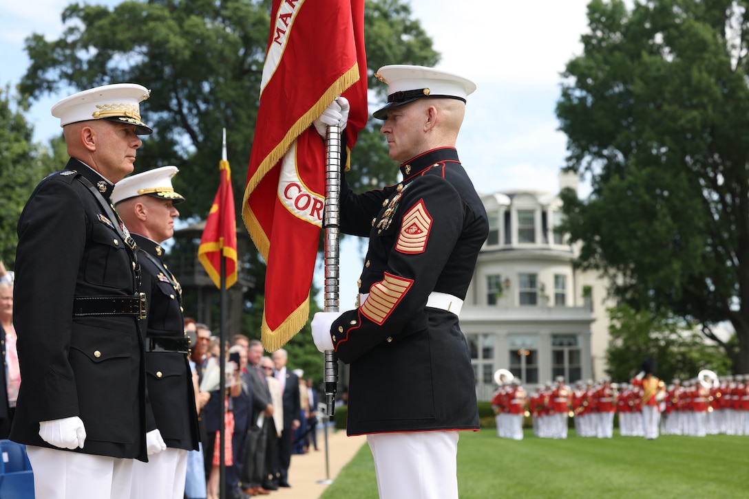 Sergeant Major of the Marine Corps Troy E. Black passes the colors to Commandant of the Marine Corps Gen. David H. Berger during a relinquishment of command ceremony at Marine Barracks Washington, D.C. on July 10, 2023.