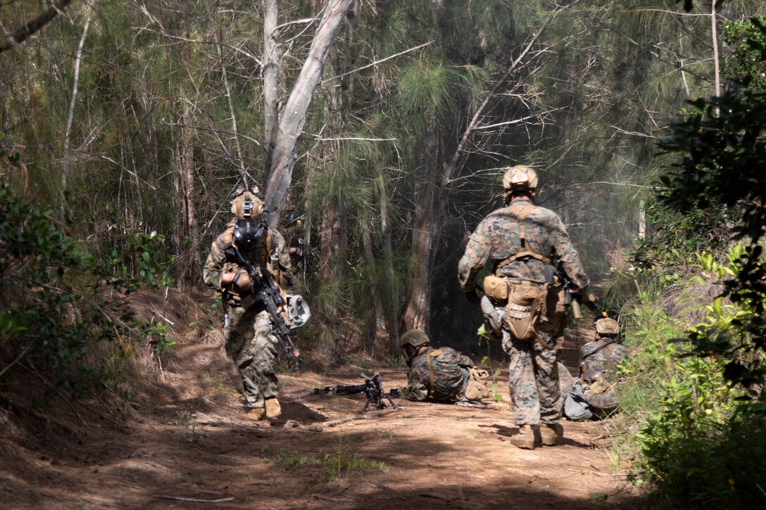 U.S. Marines with Advanced Infantry Training Battalion, School of Infantry-West, Hawaii Detachment, conduct a patrol to an enemy position while dealing with a simulated chemical threat during an Advanced Infantry Marine Course, Kahuku Training Area, Hawaii, June 27, 2023. AIMC is advanced infantry training designed to enhance and test Marines’ skills with a focus on reinforcing proper patrols and operational procedures. (U.S. Marine Corps photo by Lance Cpl. Terry Stennett III)