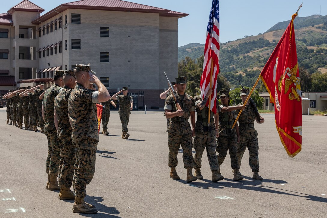 U.S. Marines with School of Infantry West march in review during the SOI-West Headquarters and Support Battalion change of command ceremony at the SOI-West parade deck on Camp Pendleton, June 29, 2023. U.S. Marine Corps Lt. Col. James Woulfe, the outgoing commanding officer H&S Bn., SOI-West, relinquished command to Lt. Col. Kurt Stahl, the incoming commanding officer.  SOI-West H&S Bn. provides the operational, administrative, logistical, and legal services necessary to support the School of Infantry's training units. (U.S. Marine Corps photo by Lance Cpl. Mhecaela J. Watts)