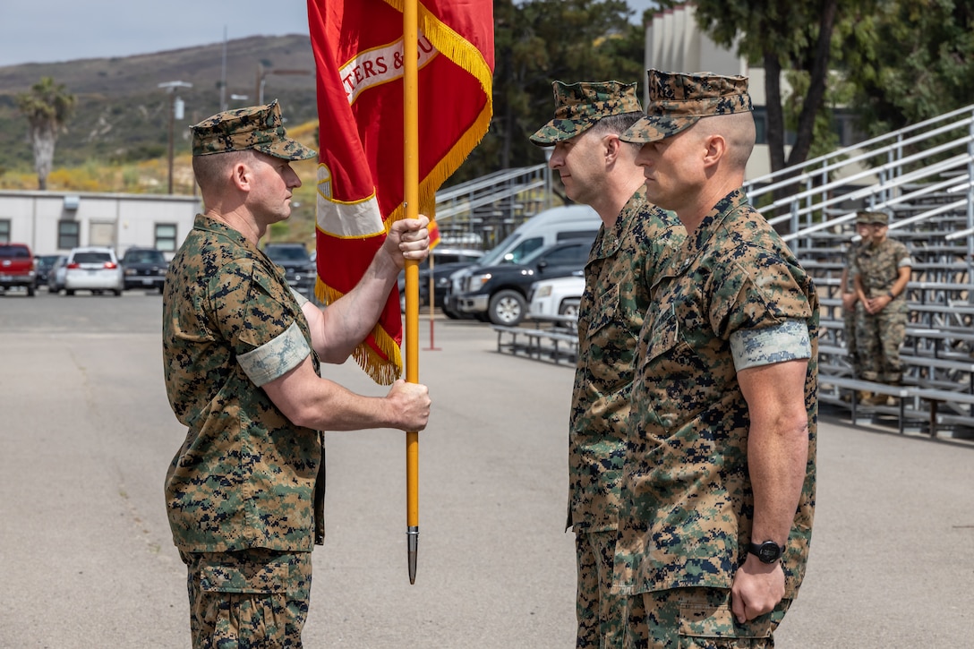 U.S. Marine Corps Sgt. Maj. Joseph Powers, left, the sergeant major of Headquarters and Support Battalion, School of Infantry West, delivers the colors to Lt. Col. James Woulfe, the outgoing commanding officer for H&S Bn., SOI-West, during a change of command ceremony at the SOI-West parade deck on Camp Pendleton, June 29, 2023. Woulfe relinquished command to Lt. Col. Kurt Stahl, the incoming commanding officer. H&S Bn., SOI-West provides the operational, administrative, logistical, and legal services necessary to support the School of Infantry's training units. (U.S. Marine Corps photo by Lance Cpl. Mhecaela J. Watts)