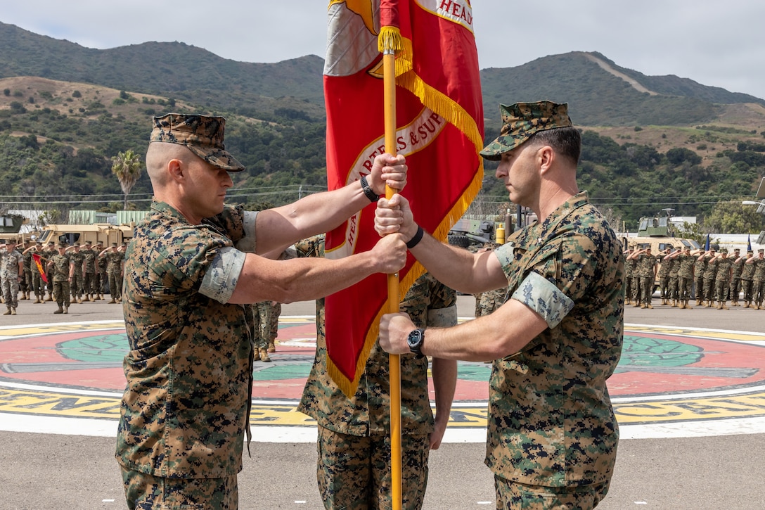 U.S. Marine Corps Lt. Col. James Woulfe, right, the outgoing commanding officer for Headquarters and Support Battalion, School of Infantry West, passes the colors to Lt. Col. Kurt Stahl, the incoming commanding officer, during a change of command ceremony at the SOI-West parade deck on Camp Pendleton, June 29, 2023. H&S Bn., SOI-West provides the operational, administrative, logistical, and legal services necessary to support the School of Infantry's training units.  (U.S. Marine Corps photo by Lance Cpl. Mhecaela J. Watts)
