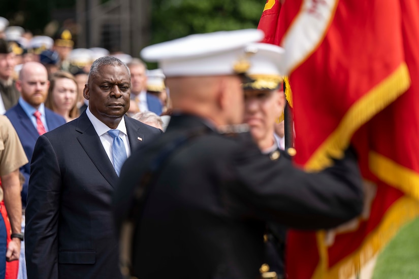 The secretary of defense participates in a ceremony.