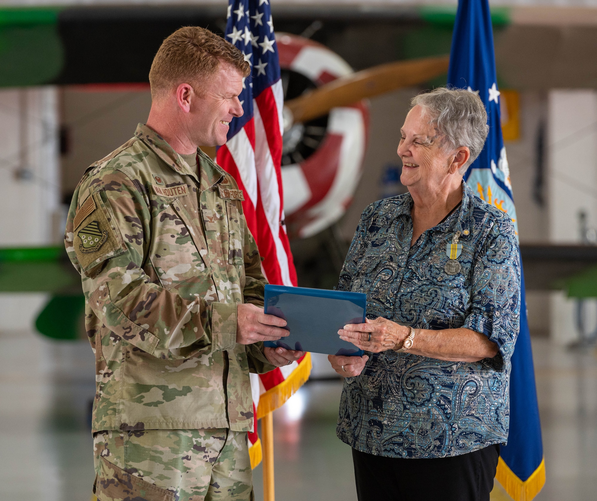 U.S. Air Force Col. Neal Van Houten, 1st Maintenance Group commander, presents an award to Vanessa Linden, 1st Maintenance Group commander’s executive assistant, during her retirement ceremony at Joint Base Langley-Eustis, Virginia, June 30, 2023.