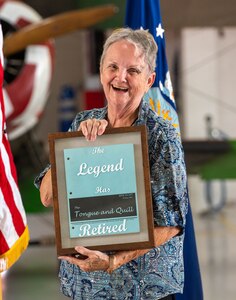 Vanessa Linden, 1st Maintenance Group executive, smiles while holding a gift during her retirement ceremony at Joint Base Langley-Eustis, Virginia, June 30, 2023.