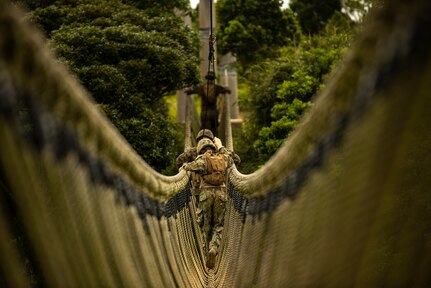 Seabees with Naval Mobile Construction Battalion (NMCB) 4, Train with Marine's from 2nd Battalion 1st Marines on how to maneuver the E-Course in Okinawa Japan. NMCB-4 is forward deployed throughout the Indo-Pacific region and United States territories to support and maintain a free and open Indo-Pacific. As the stand in, crisis response, naval engineering force, NMCB-4 maintains a ready posture to deliver in-theater expeditionary logistics via expeditionary shore infrastructure, forward damage repair, and mobile construction. (U.S Navy Photo by Utilitesman 3rd Class Nettie Manfull/Released)