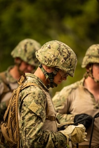 Builder Constructionman Hunter Haslip with Naval Mobile Construction Battalion (NMCB) 4, prepares to cross two rope bridges to continue the E-Course. NMCB-4 is forward deployed throughout the Indo-Pacific region and United States territories to support and maintain a free and open Indo-Pacific. As the stand in, crisis response, naval engineering force, NMCB-4 maintains a ready posture to deliver in-theater expeditionary logistics via expeditionary shore infrastructure, forward damage repair, and mobile construction. (U.S Navy Photo by Utilitesman 3rd Class Nettie Manfull/Released)