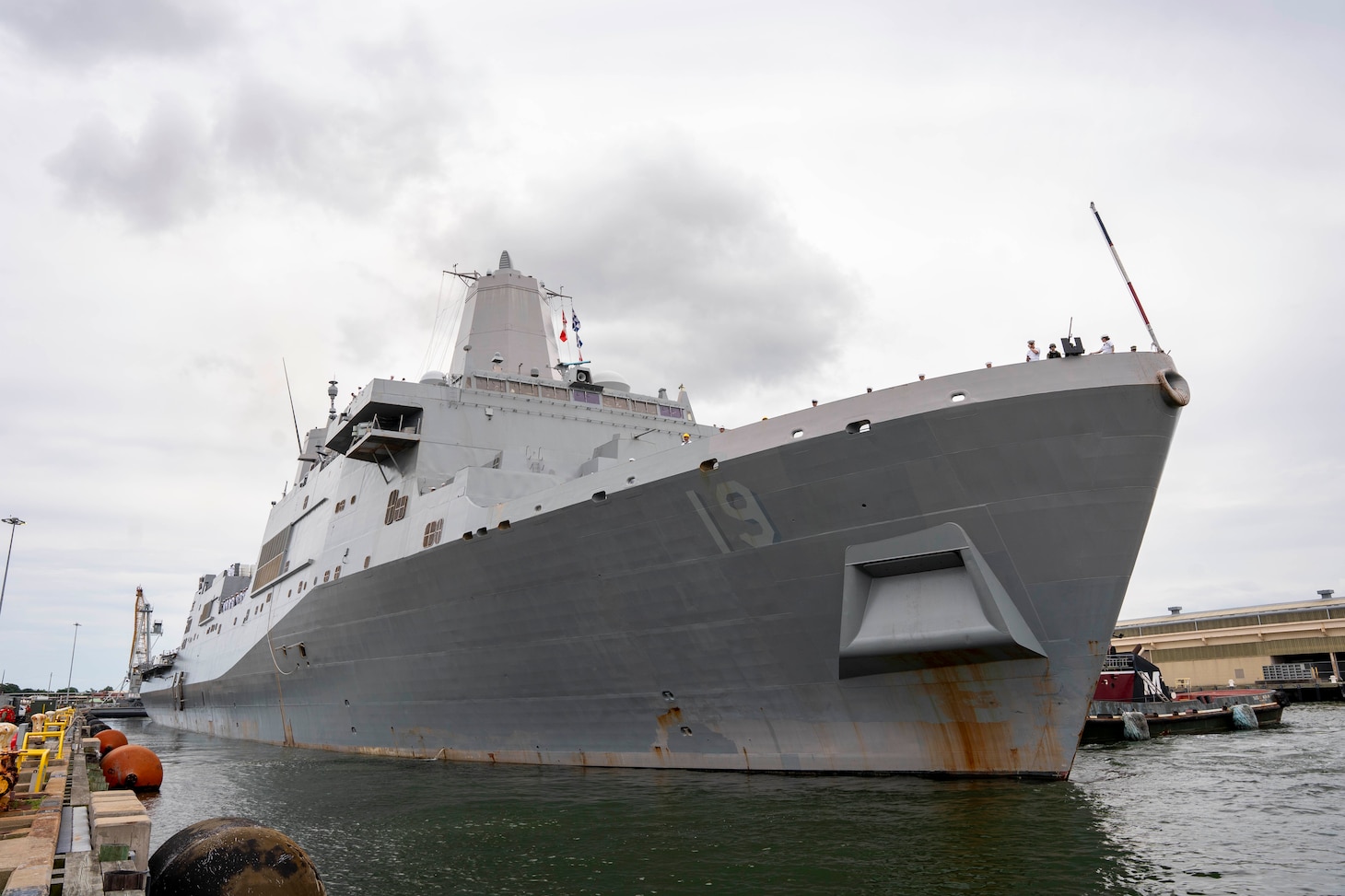 The amphibious transport dock USS Mesa Verde (LPD 19) pulls away from the pier, departing Naval Station Norfolk for a scheduled deployment, July 10, 2023.