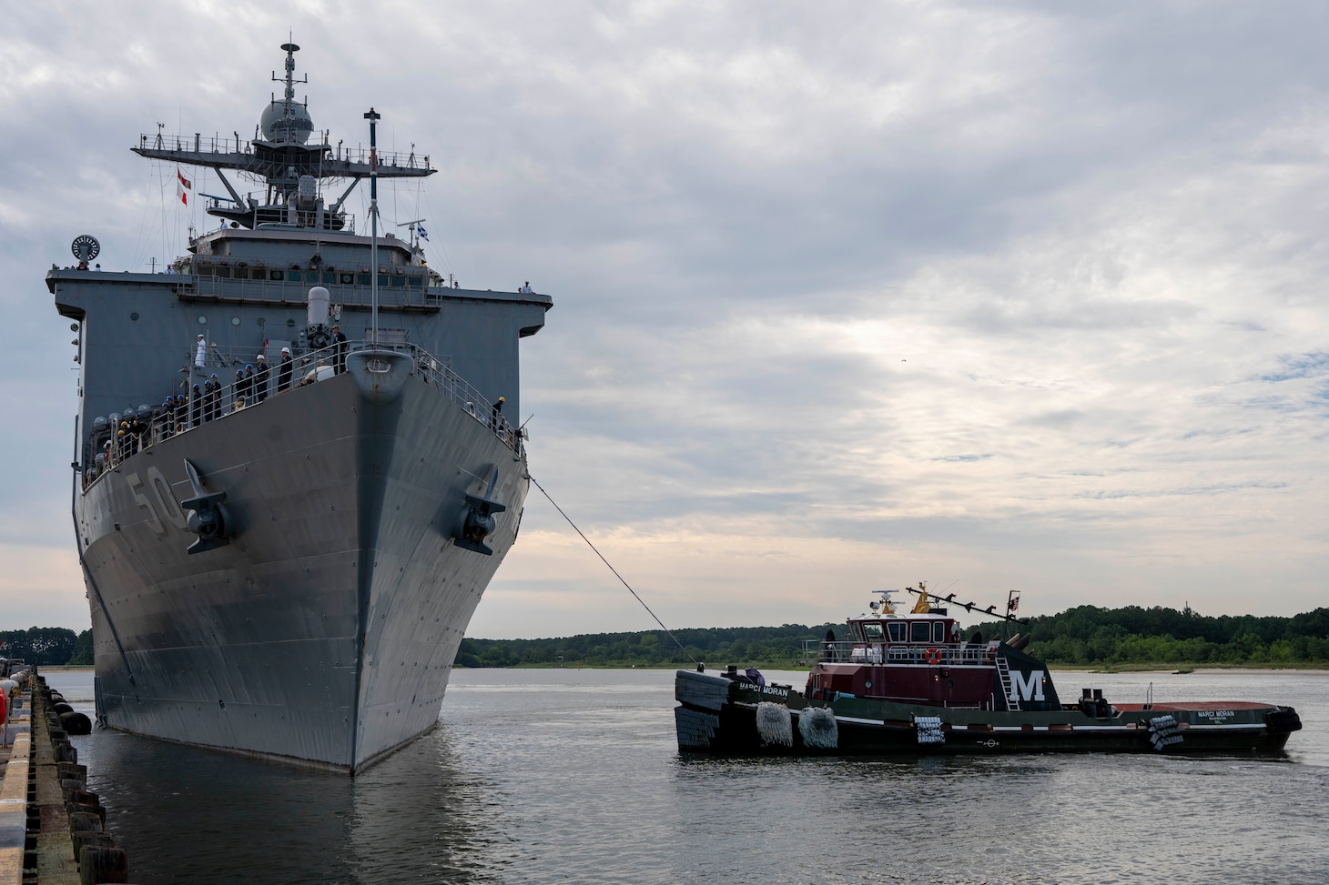 The dock landing ship USS Carter Hall (LSD 50) pulls away from the pier as they set to depart Joint Expeditionary Base Little Creek/Fort Story for a scheduled deployment, July 10, 2023.