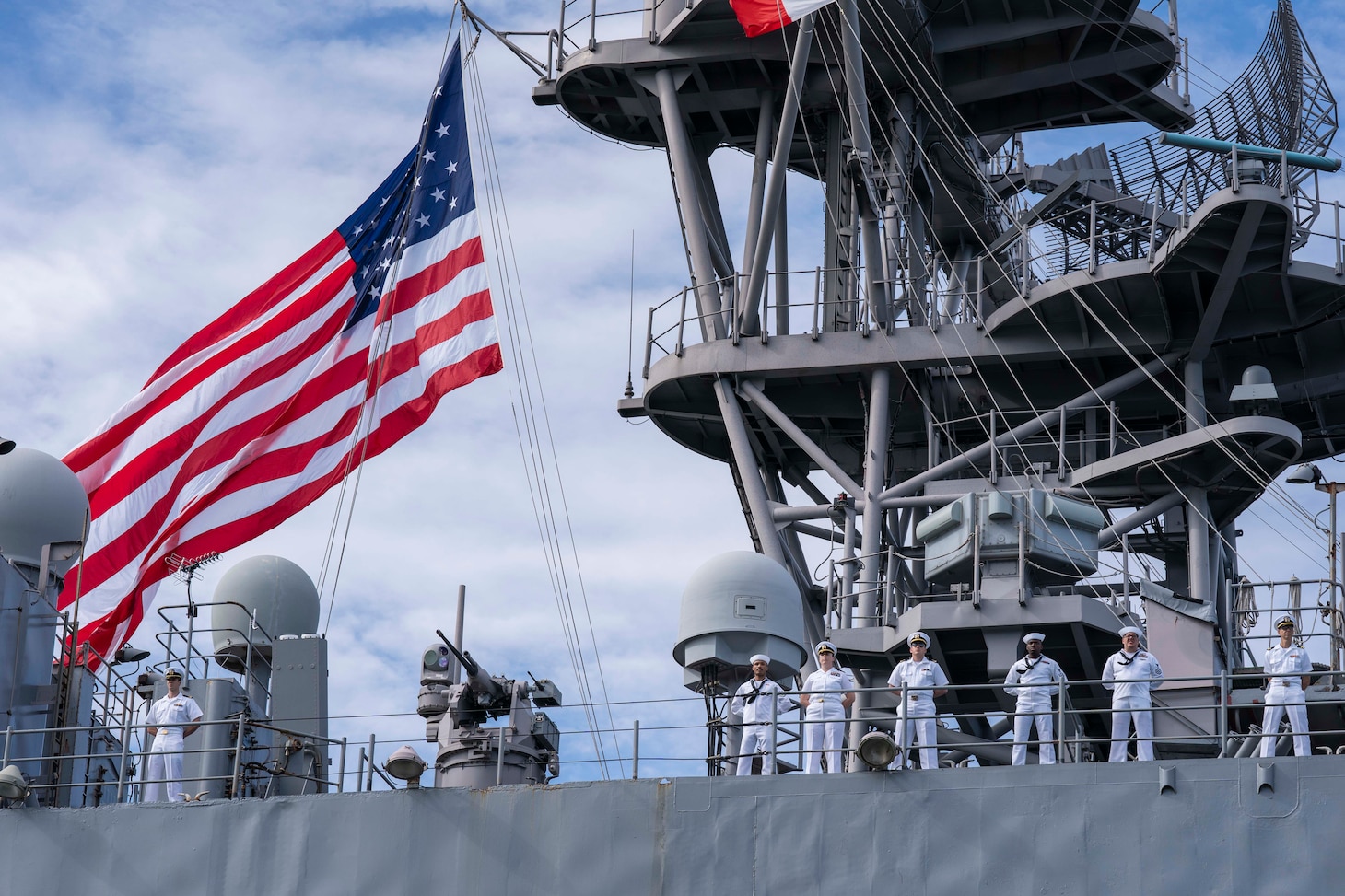 Sailors man the rails as the dock landing ship USS Carter Hall (LSD 50) departs Joint Expeditionary Base Little Creek/Fort Story for a scheduled deployment, July 10, 2023.