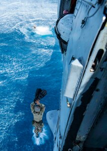 A Sailor assigned to Task Group 75.1/ Explosive Ordnance Disposal Mobile Unit (EODMU) 5 jumps from a MH-60S Sea Hawk helicopter from Helicopter Sea Combat Squadron (HSC) 21, during a training evolution. Part of Destroyer Squadron Seven, HSC-21 is assigned to Independence-variant littoral combat ship USS Tulsa (LCS 16), on a rotational deployment operating in the U.S. 7th fleet area of operations to enhance interoperability with partners and serve as a ready-response force in support of a free and open Indo-Pacific region. (U.S. Navy photo by Mass Communication Specialist 2nd Class Colby Mothershead)