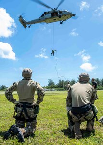 APRA HARBOR, Guam (June 2, 2021) Sailors assigned to Task Group 75.1/Explosive Ordnance Disposal Mobile Unit (EODMU) 5 practice repelling from a MH-60S Sea Hawk helicopter from Helicopter Sea Combat Squadron (HSC) 21, during a training evolution on CTG 75.1/EODMU 5’s compound. Part of Destroyer Squadron Seven, HSC-21 is assigned to Independence-variant littoral combat ship USS Tulsa (LCS 16), on a rotational deployment operating in the U.S. 7th fleet area of operations to enhance interoperability with partners and serve as a ready-response force in support of a free and open Indo-Pacific region. (U.S. Navy photo by Mass Communication Specialist 2nd Class Colby Mothershead)