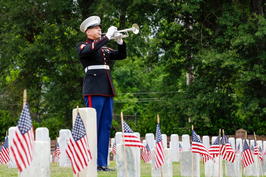 U.S. Marine Corps Sgt. Taylor Brown, a musician with the 2nd Marine Aircraft Wing Band, holds his post during the New Bern National Cemetery Memorial Day ceremony at New Bern, North Carolina, May 29, 2023. Memorial Day has been a time-honored, annual tradition since its inception in 1868, by Union Army Brig. Gen John Logan, to honor and remember those who sacrificed their lives in defense of our nation. (U.S. Marine Corps photo by Cpl. Noah Braswell)