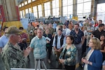 Capt. Richard Jones, Pearl Harbor Naval Shipyard commander, left, shares the mission of the shipyard with, left to right, Rep. Ed Case, Sen. Mazie Hirono, and Deputy Secretary of Defense Kathleen Hicks, during a tour of Pearl Harbor Naval Shipyard.