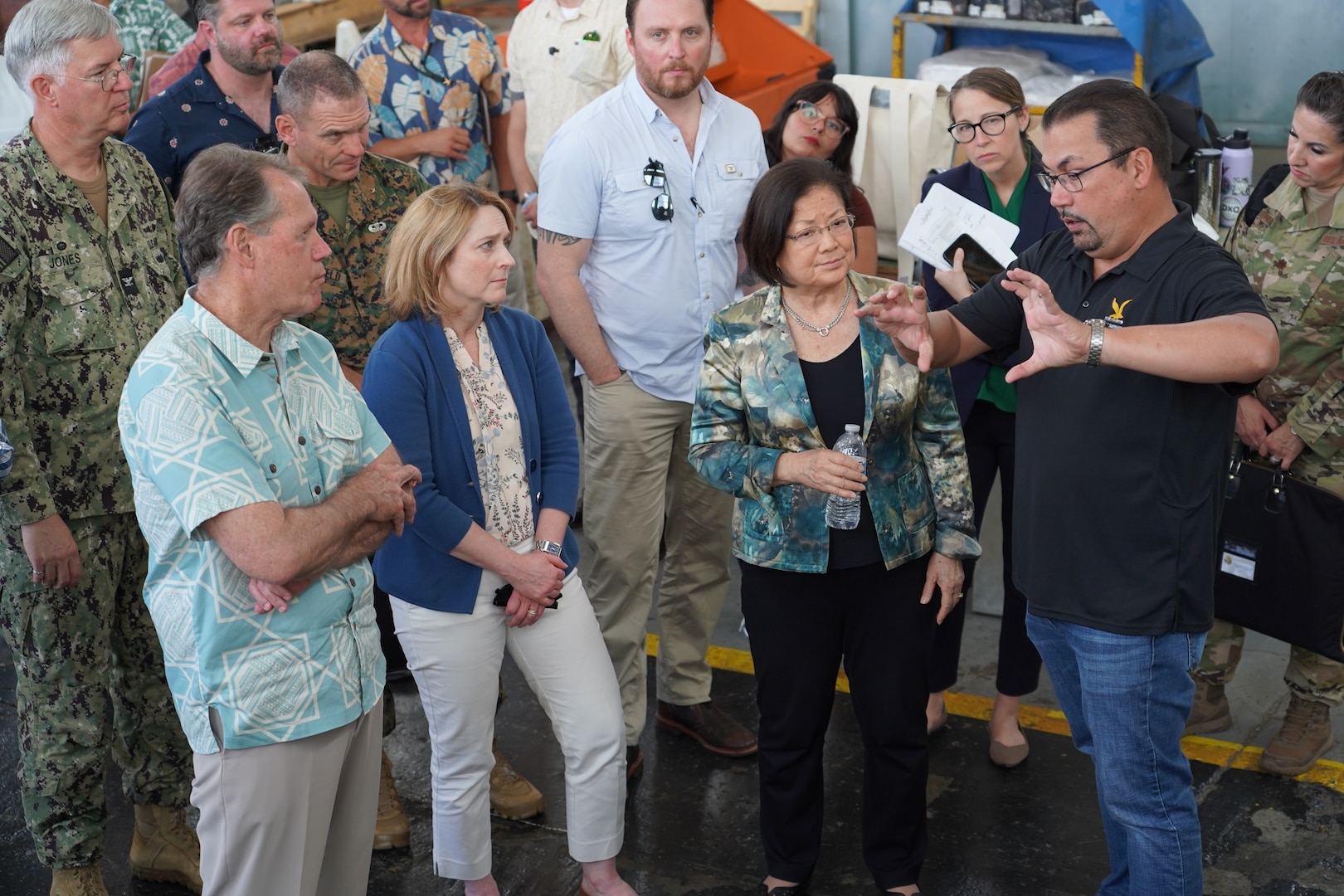 Deputy Secretary of Defense Kathleen Hicks, second from the left, Sen. Mazie Hirono, second from the right, Rep. Ed Case, left, receives a briefing during a tour of Pearl Harbor Naval Shipyard (PHNSY), Hawai’i, from John Morgan, Mechanical Superintendent for Code 930 (Shops 931/938).
