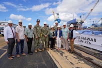 Deputy Secretary of Defense Kathleen Hicks, third from right, poses for a photo with shipyard leadership and state representatives, during a tour of Pearl Harbor Naval Shipyard
