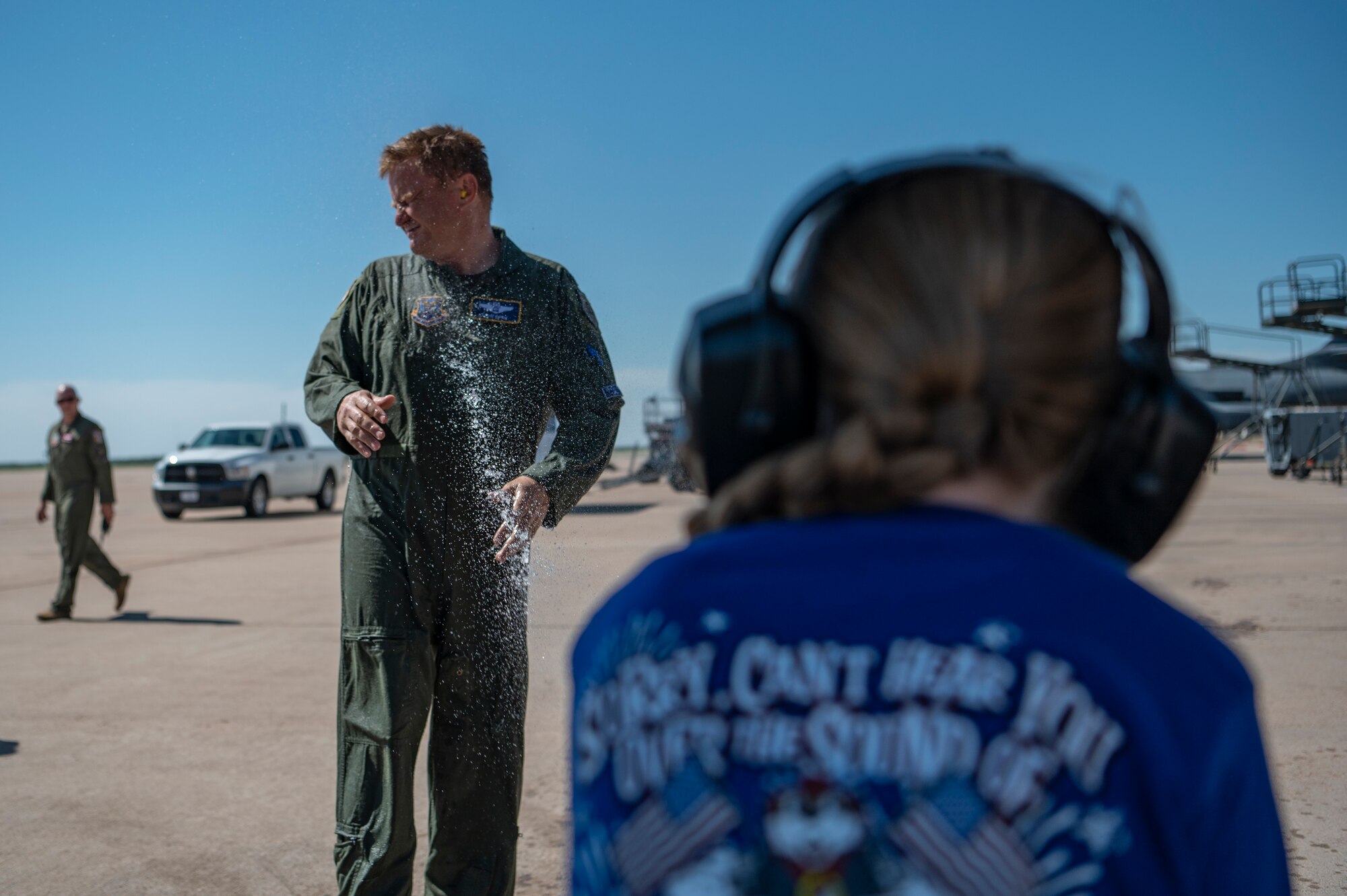 U.S. Air Force Col. Kevin Kippie, 7th Bomb Wing vice commander, gets sprayed by his daughter Jennifer Kippie at Dyess Air Force Base, Texas, June 29, 2023. Kippie served at Dyess from June 11, 2021, to June 16, 2023. While at Dyess, Kippie was committed to excellence as he fostered financial innovation and proposals for the installation, created a Wing Welcome Center for new Airmen and worked in integrated teams to action the wing’s fiscal efforts. (U.S. Air Force photo by Senior Airman Ryan Hayman)