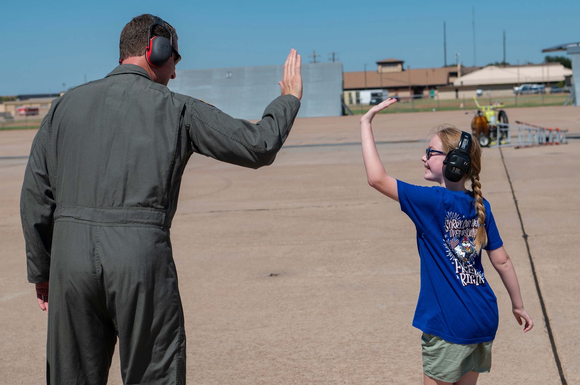 U.S. Air Force Col. Joseph Kramer, 7th Bomb Wing commander, high fives Jennifer Kippie, daughter of Col. Kevin Kippie, 7th BW vice commander, at Dyess Air Force Base, Texas, June 29, 2023. Kippie served at Dyess from June 11, 2021, to June 16, 2023. While at Dyess, Kippie was committed to excellence as he fostered financial innovation and proposals for the installation, created a Wing Welcome Center for new Airmen and worked in integrated teams to action the wing’s fiscal efforts. (U.S. Air Force photo by Senior Airman Ryan Hayman)
