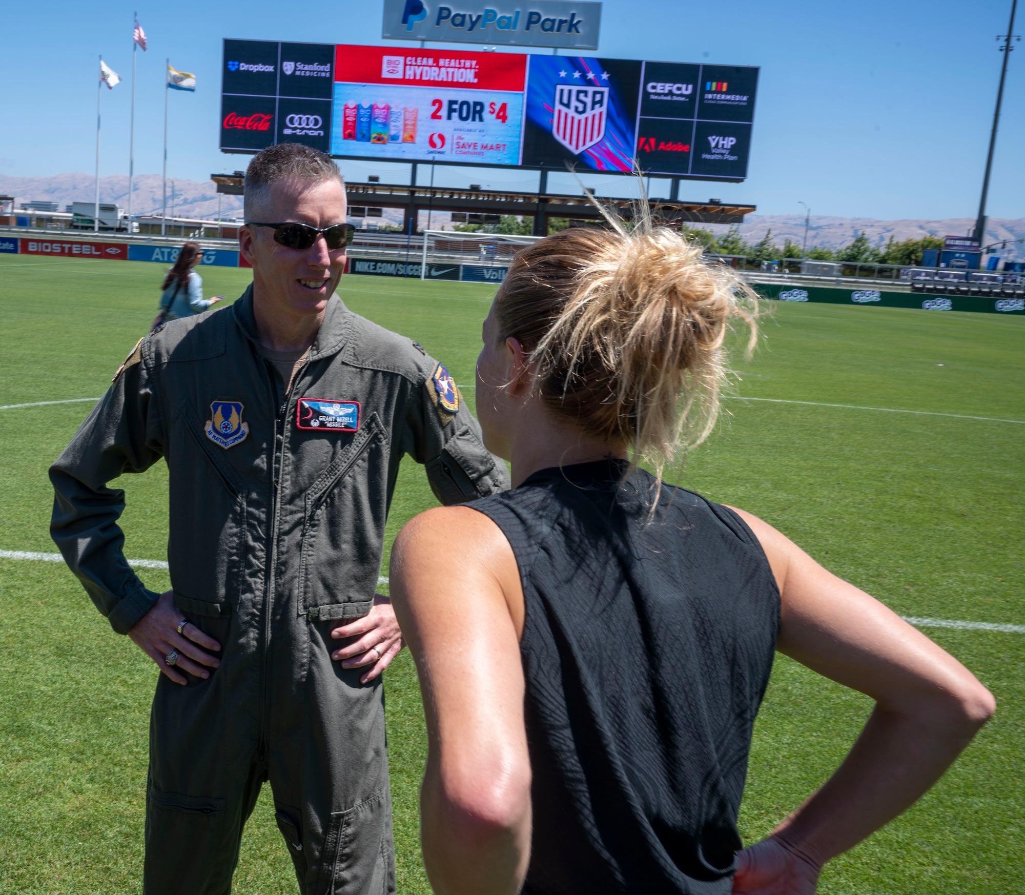 Col. Grant Mizell, Commander, 412th Operations Group chats with an U.S. Women's National Team player. Team Edwards sent an all female crew from the 412th Operations Group to conduct a special flyover for the National Women's Soccer League at PayPal Park, July 9 in San Jose, California.