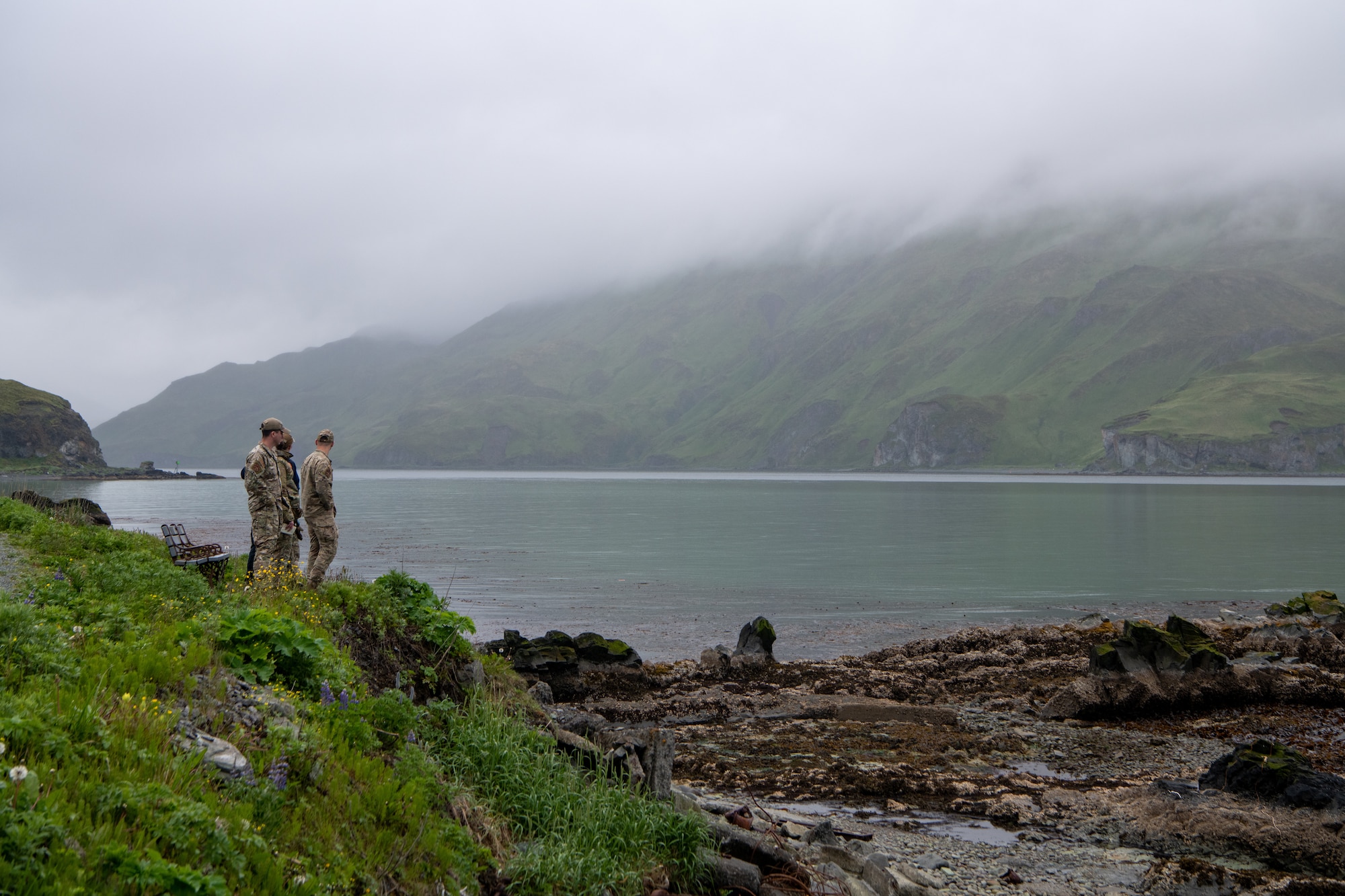 A photo of EOD technicians surveying the site of a potential UXO.