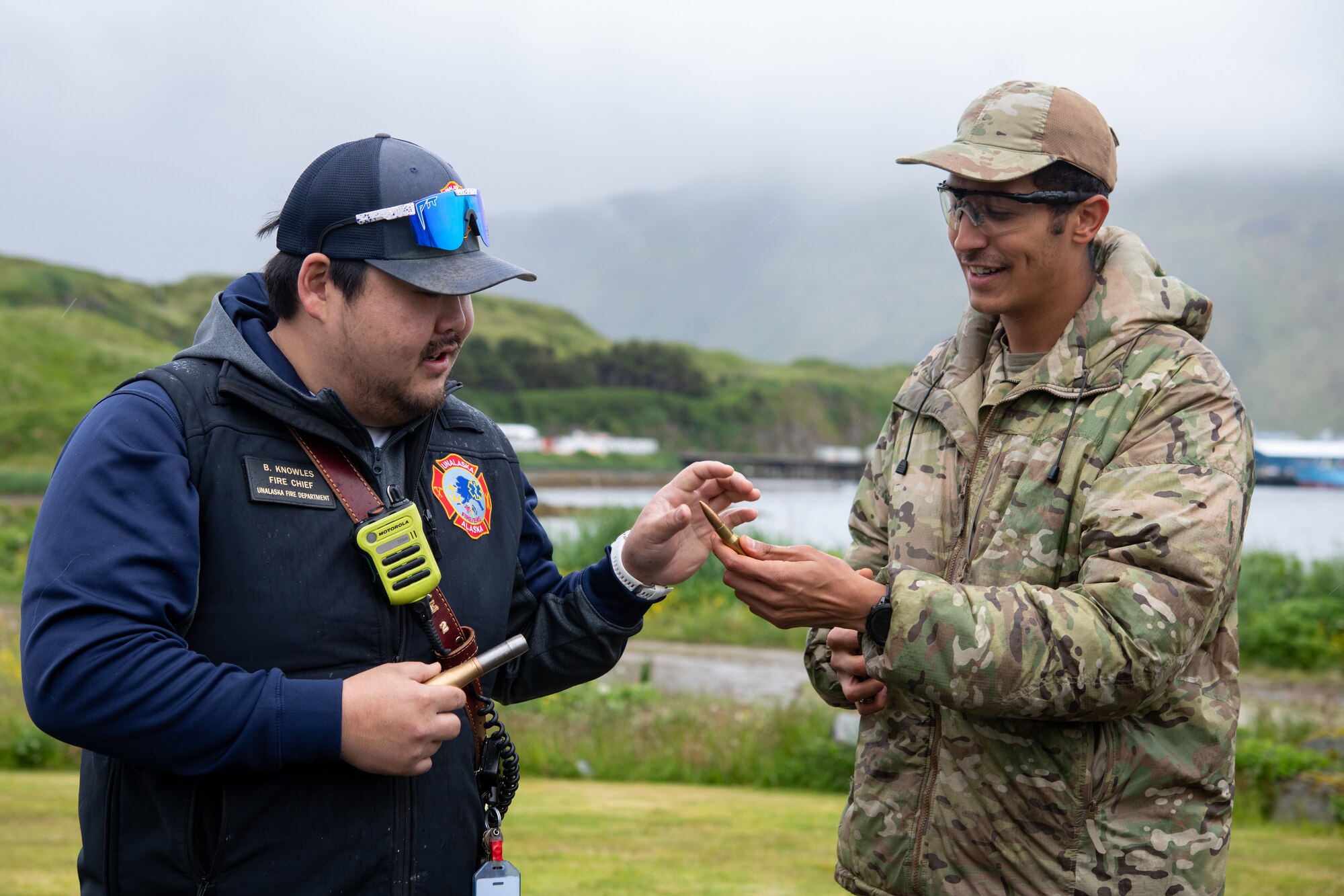 A photo of local law enforcement handing bullets over to an EOD technician.