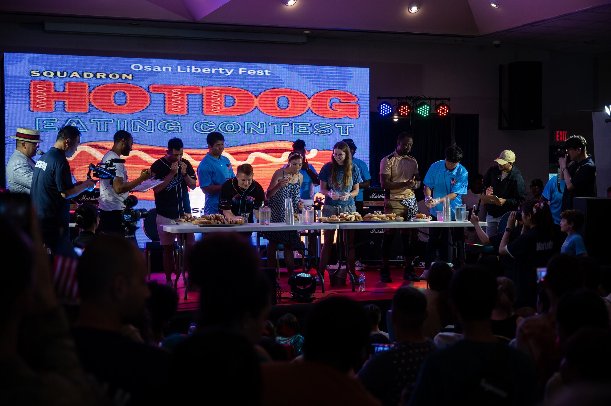 A hotdog eating contest takes place during the Liberty Fest event at Osan Air Base, Republic of Korea, July 4, 2023. The event included multiple live performances, a hotdog eating contest, and prize giveaways to celebrate America’s Independence Day. (U.S. Air Force photo by Senior Airman Thomas Sjoberg)