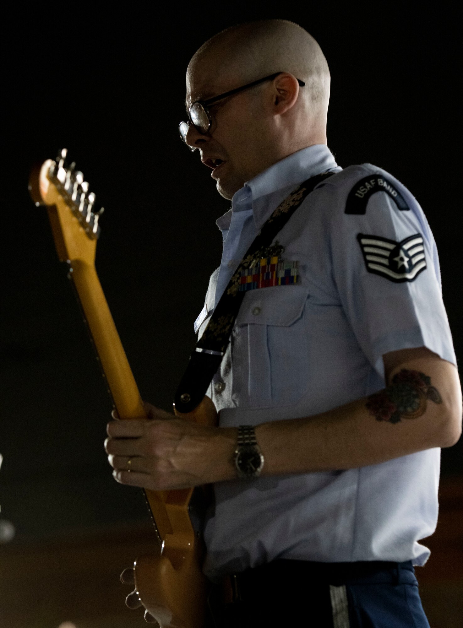 A military electric guitarist takes a deep breath as he plays
