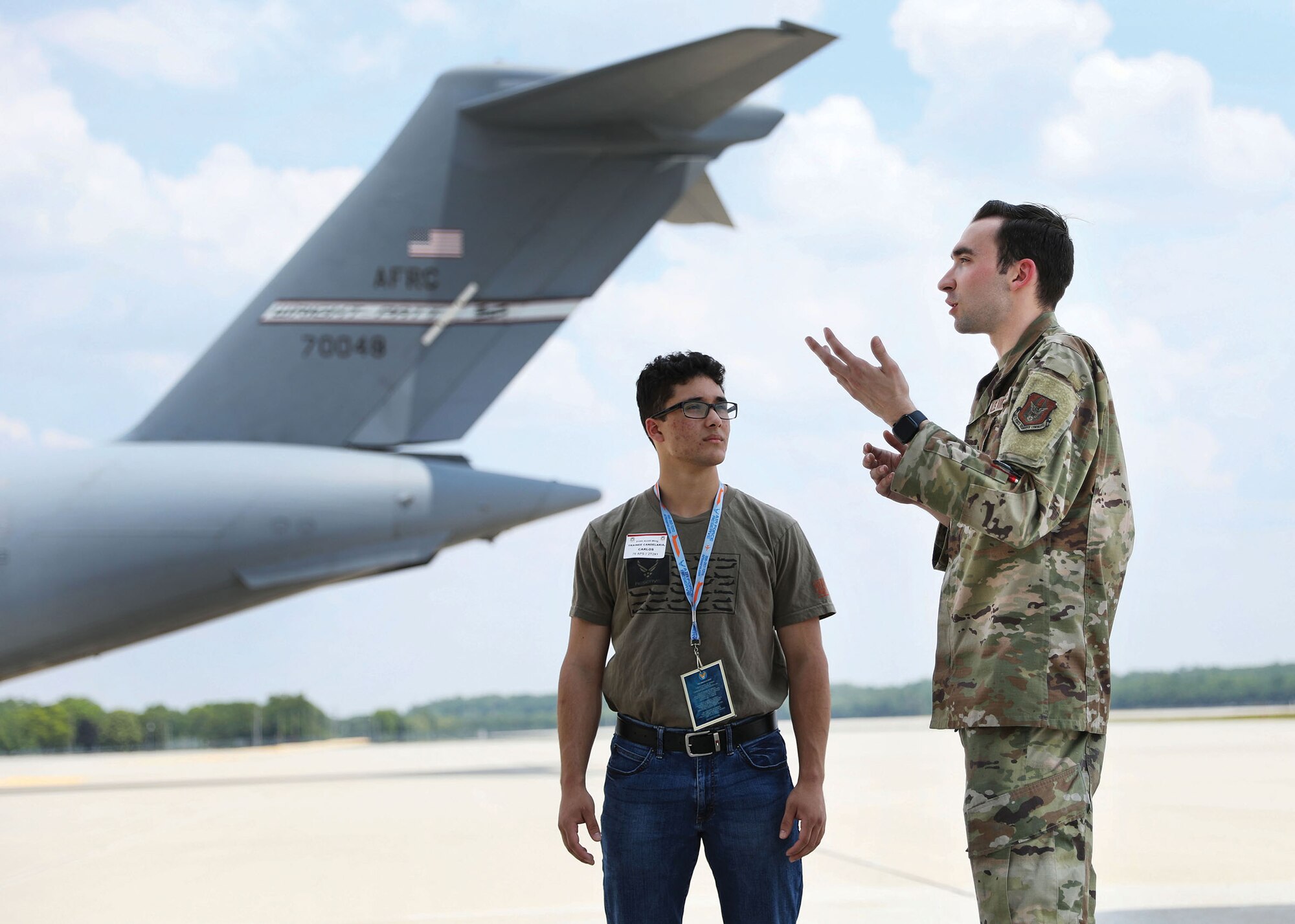 Staff Sgt. Weston Emanuelson, 445th Aircraft Maintenance Squadron crew chief, and Carlos Candelaria, Development and Training Flight trainee from Youngstown Air Reserve Station, Ohio, discuss C-17 Globemaster III capabilities during an aircraft tour, June 3, 2023