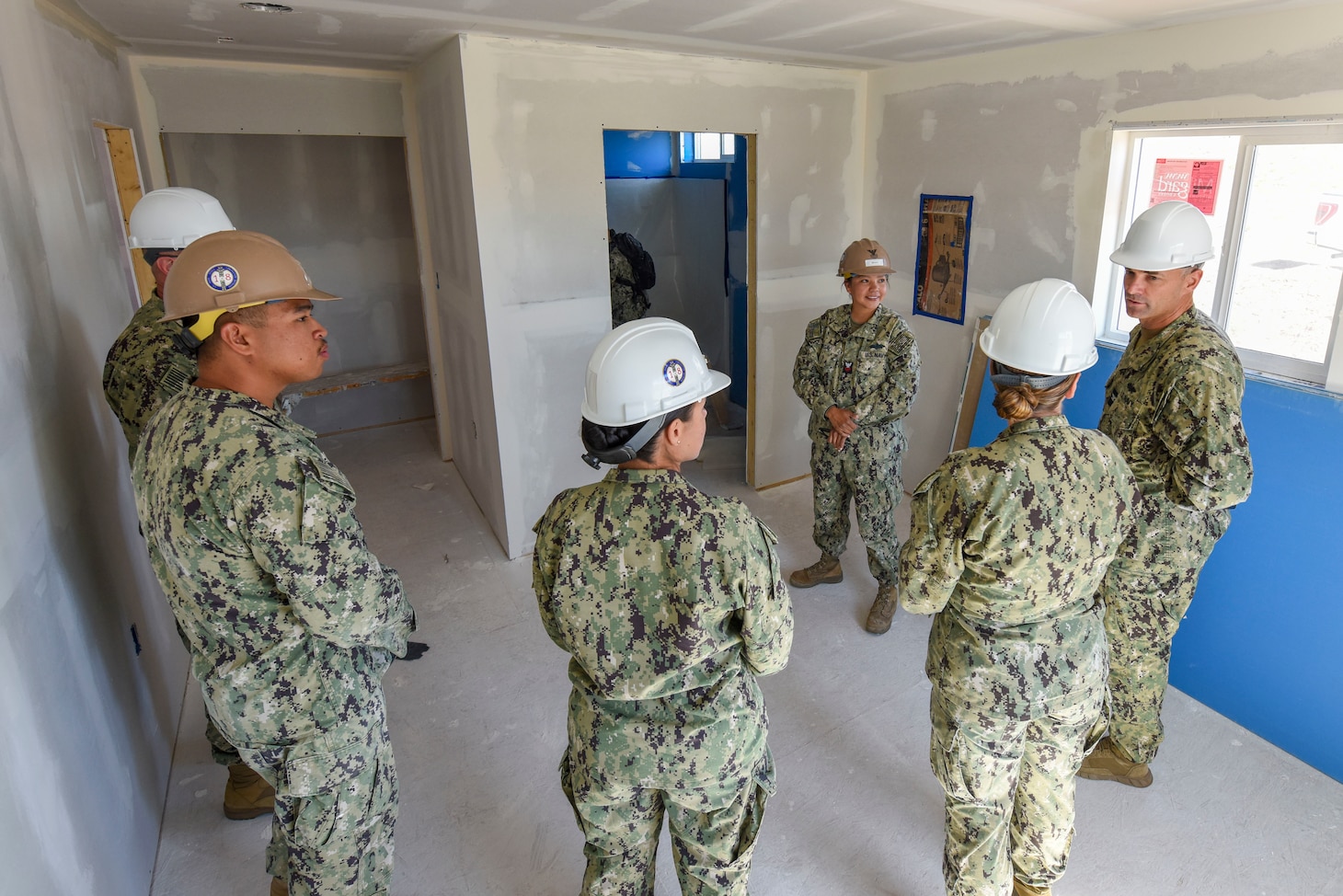GALLUP, N.M. (June 15, 2023) Navy Reserve Sailors pose for a group photo in front of a newly constructed home they built as a charitable contribution and training opportunity in partnership with the Southwest Indian Foundation. The home's construction served to educate Seabees in various practical construction techniques needed for mission readiness while fulfilling the needs of a community partner as part of the Department of Defense's Innovative Readiness Training (IRT) program. Representatives from Naval Mobile Construction Battalion (NMCB) 18, FIRST Naval Construction Regiment (FIRST NCR) and Southwest Indian Foundation are depicted.