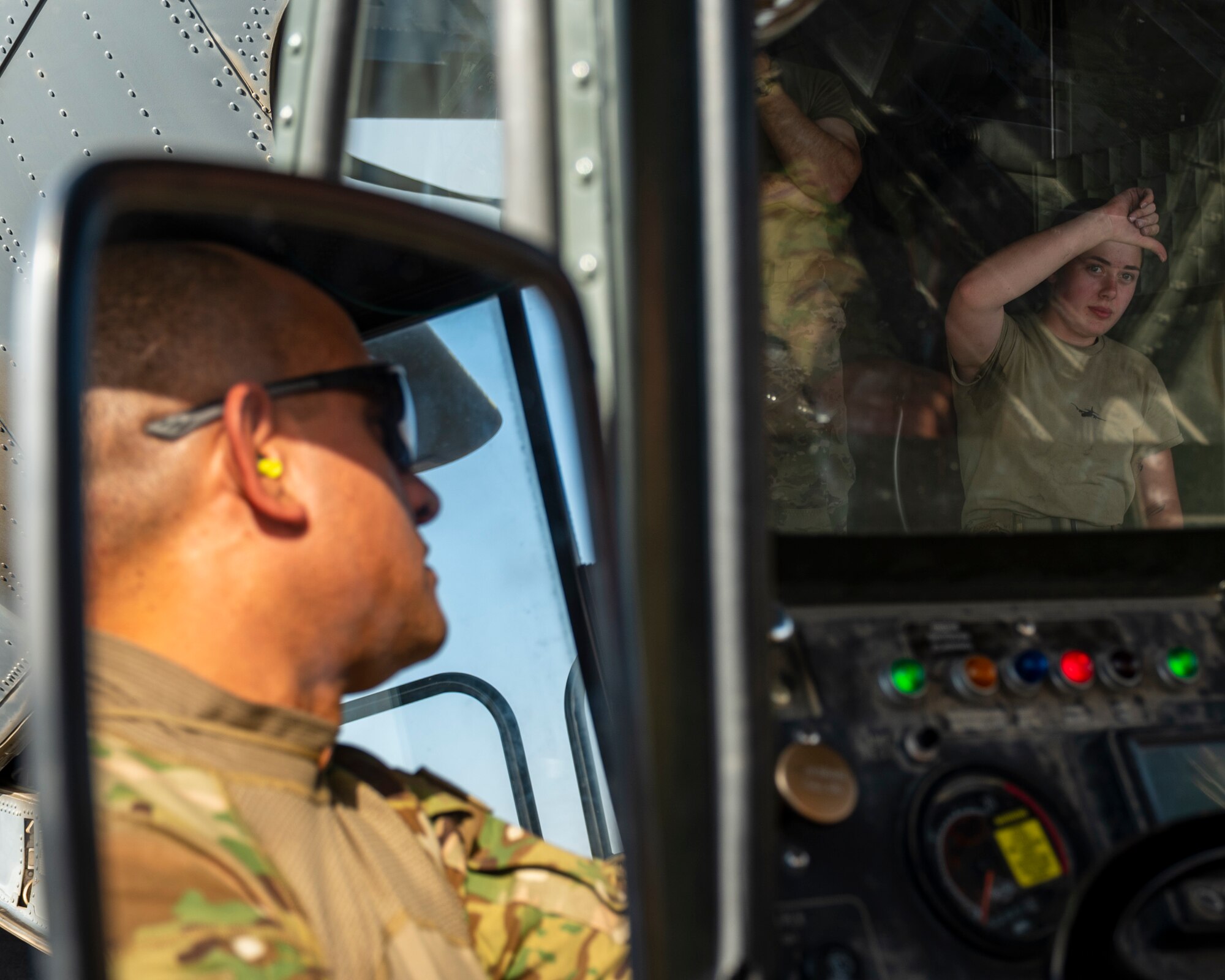 U.S. Air Force Airman 1st Class Tess Pouliot, 40th Expeditionary Airlift Squadron C-130 loadmaster, marshals a 60k cargo loader to an awaiting aircraft at Ali Al Salem Air Base, Kuwait, July 5, 2023.
