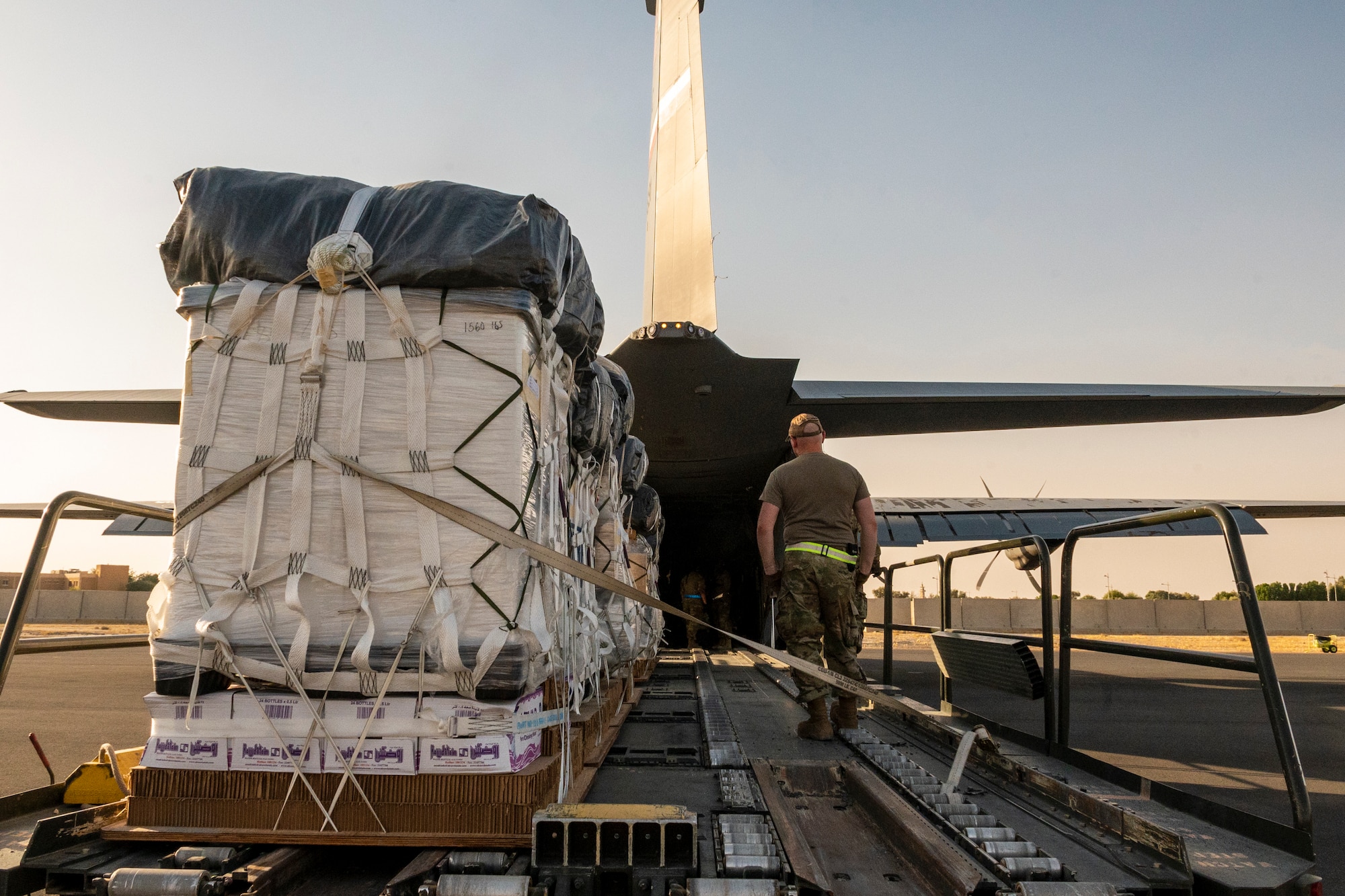 U.S. Air Force members from the 40th Expeditionary Airlift Squadron, team with U.S. Army members from the 165th Quartermaster Company, Detachment 1, to load a C-130 aircraft with cargo at Ali Al Salem Air Base, Kuwait, July 5, 2023.