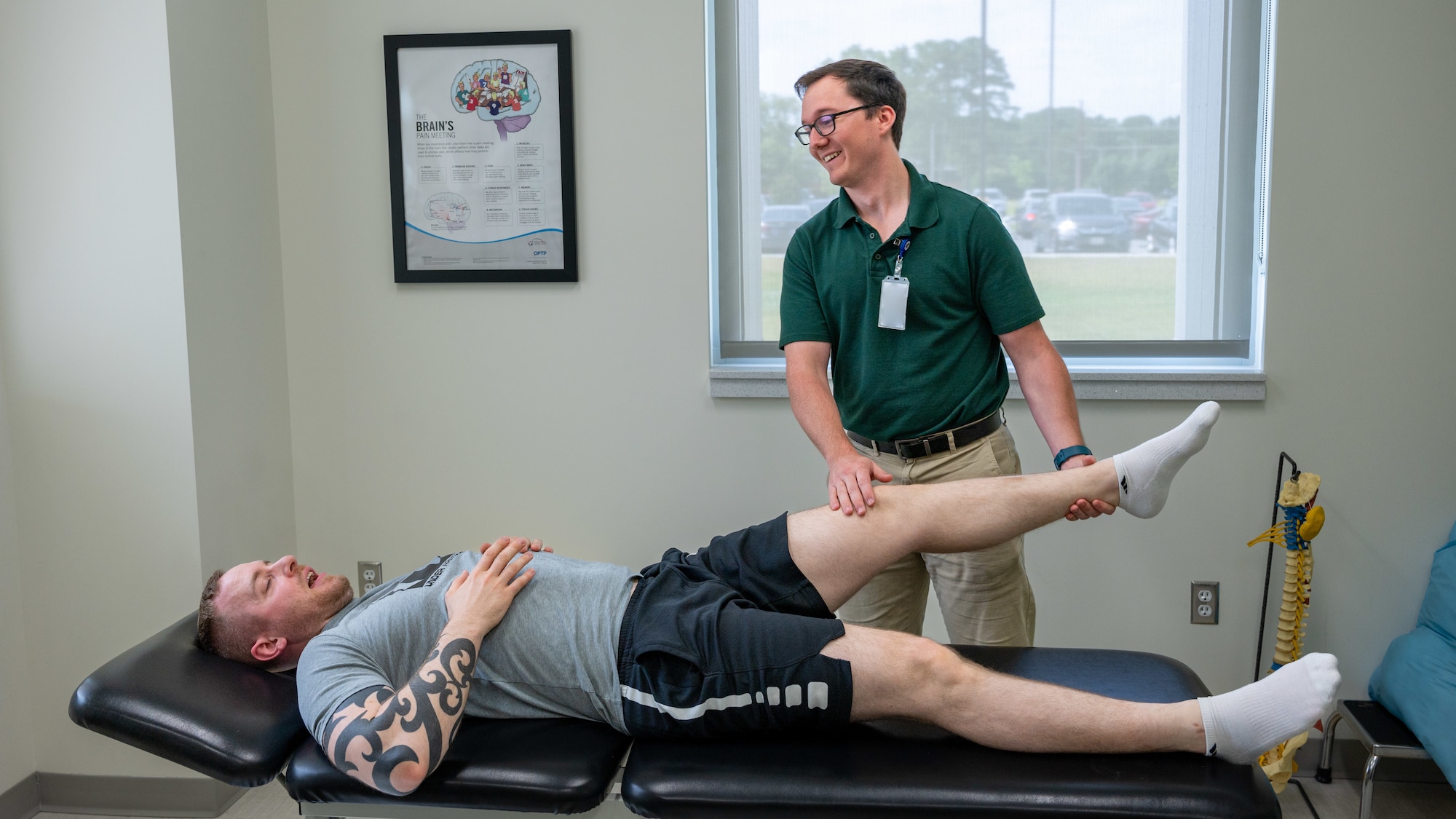 Cameron Perntis, right, 4th Operational Medical Readiness Squadron physical therapy clinic civilian physical therapist assistant contractor, assesses the injury of Staff Sgt. Trevor Herrli, 333rd Fighter Generation Squadron weapons load team chief at Seymour Johnson Air Force Base, North Carolina, June 22, 2023. The physical therapy clinic’s vision is to maintain professional Airmen ready to fight, and one of the wing commander’s priorities is to improve combat readiness. (U.S. Air Force photo by Airman 1st Class Leighton Lucero) (This photo was adjusted for security reasons)