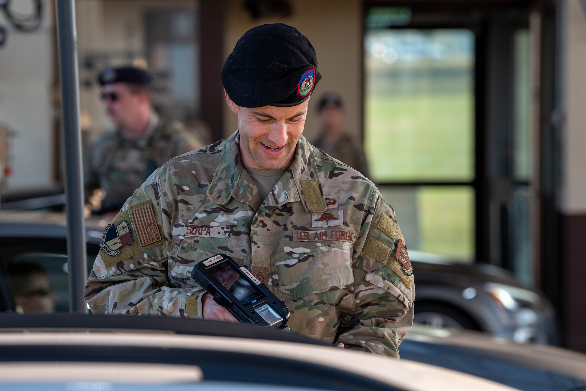 U.S. Air Force Chief Master Sgt. Evan Serpa, 52nd Fighter Wing command chief, checks IDs alongside members of the 52nd Security Forces Squadron at the main gate for Spangdahlem Air Base, Germany.