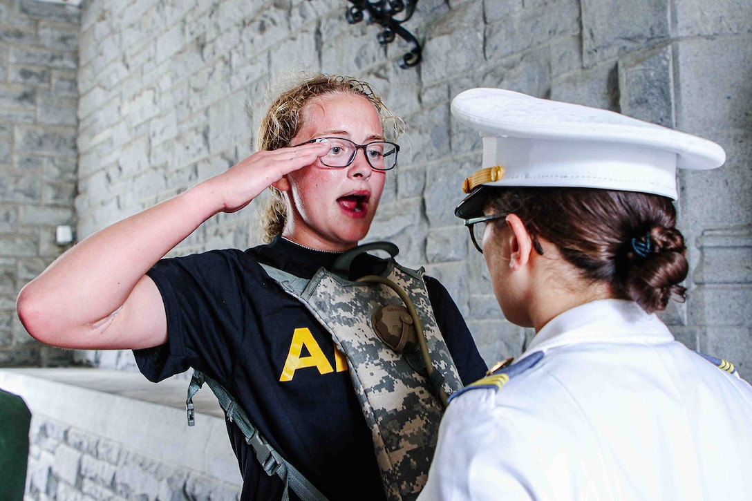 A West Point cadet salutes a superior during training.