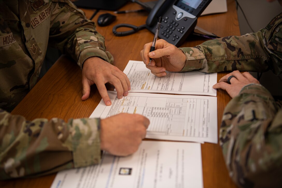 U.S. Airman 1st Class Leonid Soubbotine, 23rd Wing Public Affairs Specialist, fills out an in-processing sheet at Moody Air Force Base, Georgia, June 21, 2023. The Moody Welcome Center opened in January 2023 and offers a hybrid version of customer service using a combination of the Comptroller Services Portal while also providing face-to-face services. (U.S. Air Force photo by Airman 1st Class Whitney Gillespie)