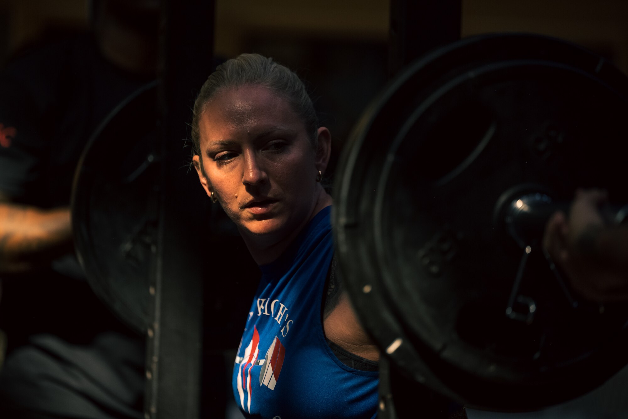 Brianna Smith, Team Holloman spouse, performs a back squat during a weightlifting meet at Holloman Air Force Base, New Mexico, July 8th, 2023. The 49th FSS hosts monthly events that encourage Airmen to excel in personal physical fitness, one of the pillars of the comprehensive Airmen fitness. (U.S. Air Force by Senior Airman Antonio Salfran)