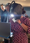 LaQuena Tolliver, Lead Logistics Management Specialist at TACOM, uses a virtual reality headset alongside LIFT representatives to simulate welding training at the TACOM-LIFT’s Industry 4.0 seminar series. (Adam Sikes)