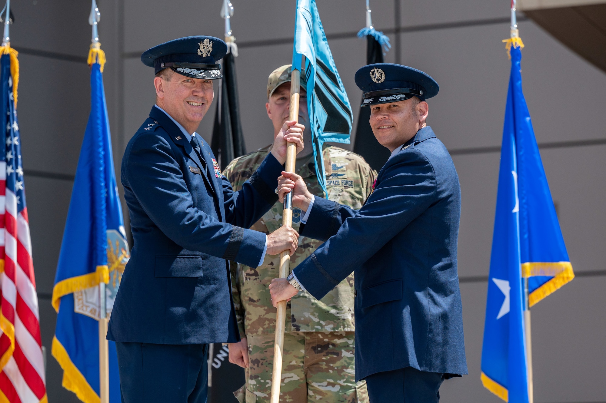 U.S. Space Force Col. Kyle Pumroy, the Delta 11 outgoing commander, right, relinquishes command of Delta 11 during a change of command ceremony at Schriever Space Force Base, Colorado, July 7, 2023. Delta 11 is responsible for delivering realistic, threat-informed test and training resources to U.S. Space Force, joint, and coalition space operators via live, virtual, and constructive threat replication, leveraging the National Space Test and Training Complex across multiple space warfighting disciplines. (U.S. Space Force photo by Ethan Johnson)