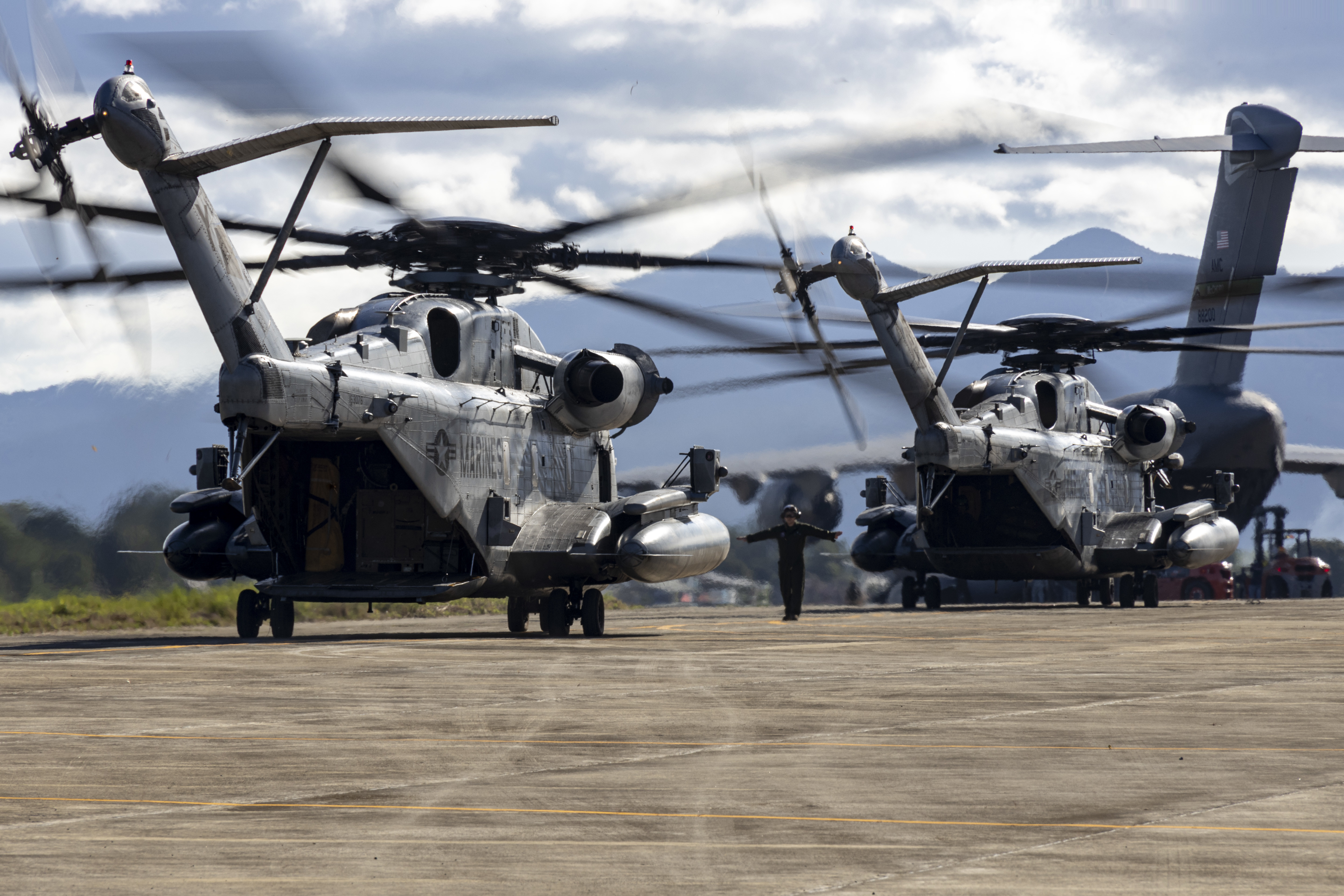 U.S. Marine Corps CH-53E Super Stallions attached to Marine Medium Tiltrotor Squadron (VMM) 163 (Reinforced), Marine Aircraft Group 16, 3rd Marine Aircraft Wing, taxi on the runway at Antonio Bautista Air Base